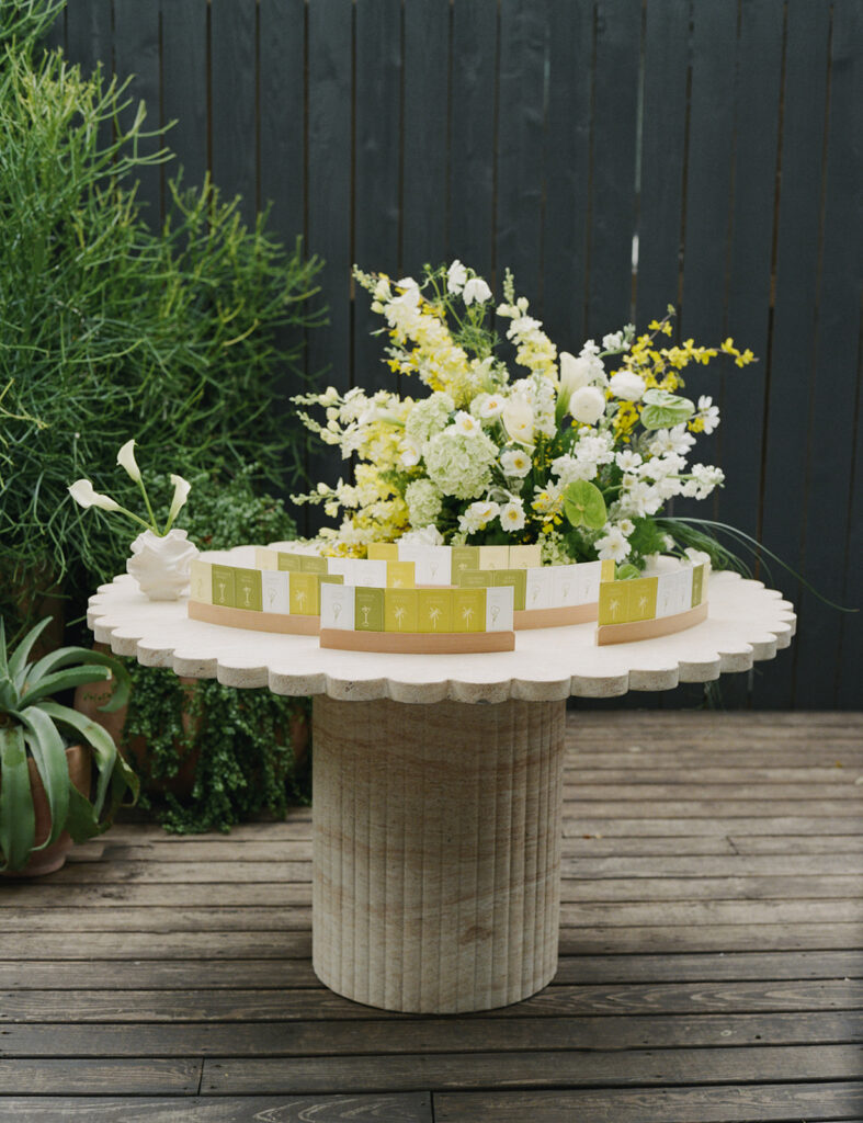 A scalloped table with a creative escort card display